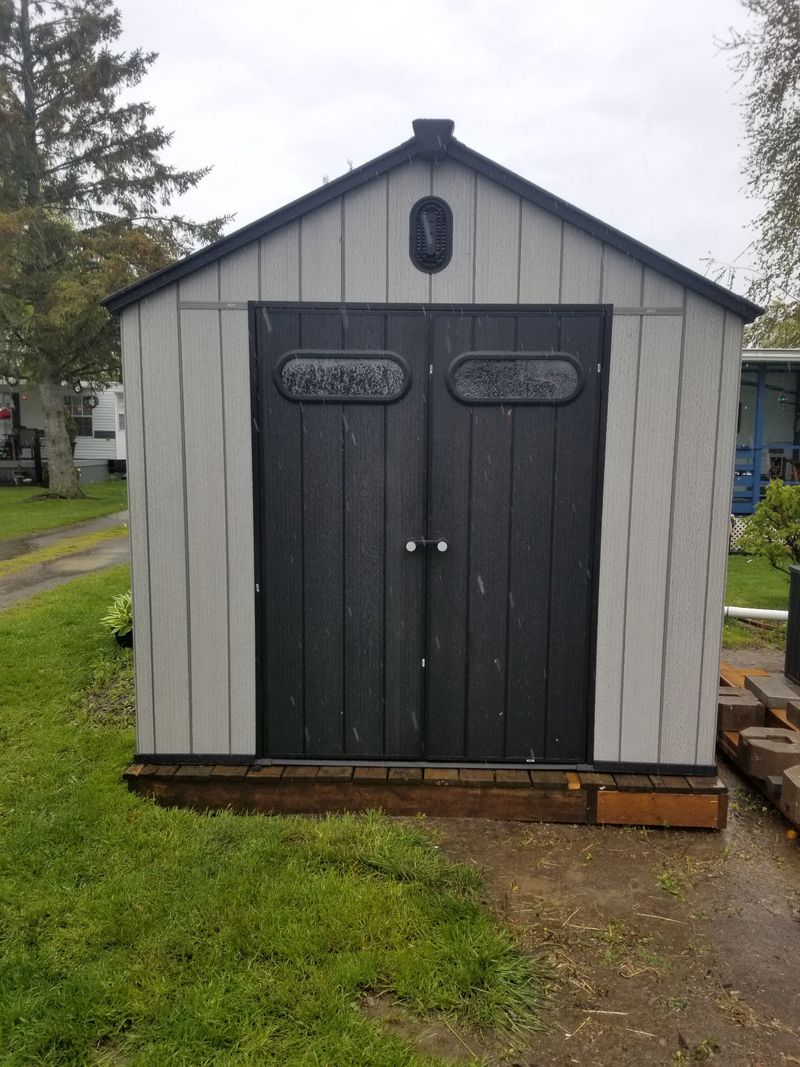 Resin shed angle view in residential setting, Peterborough Ontario